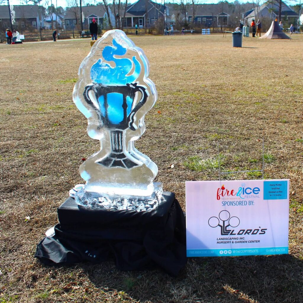 a trophy sitting on top of a field next to a sign