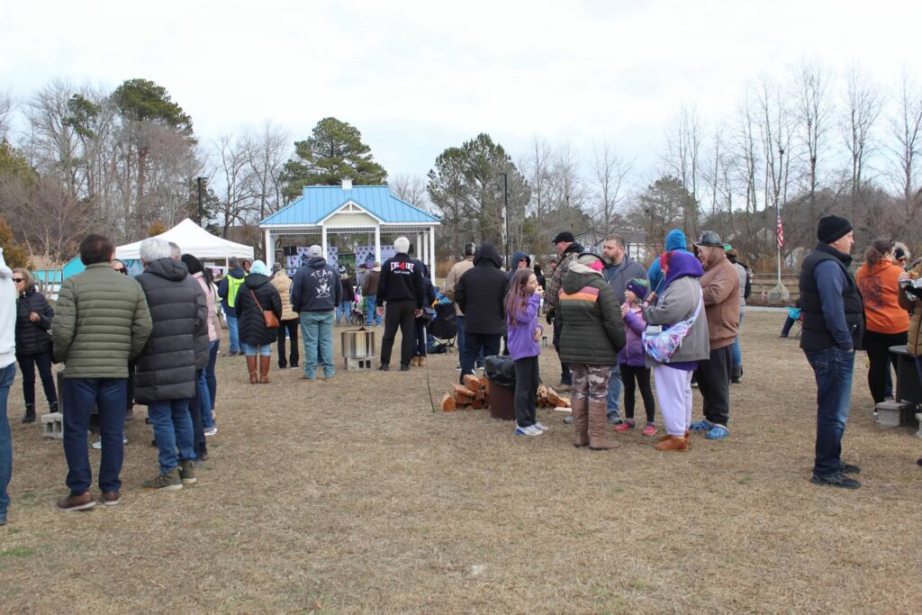 a group of people standing in a field