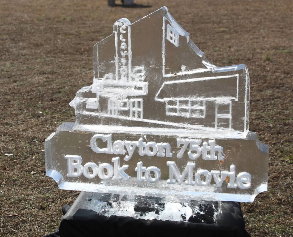 a crystal book to movie sign sitting in the grass
