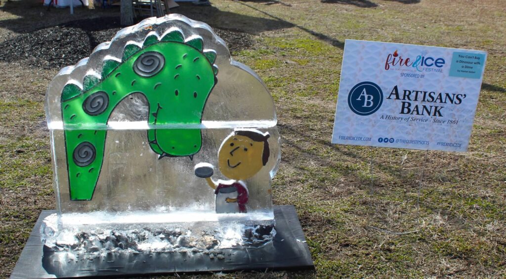 a sculpture of a green plant on a metal stand