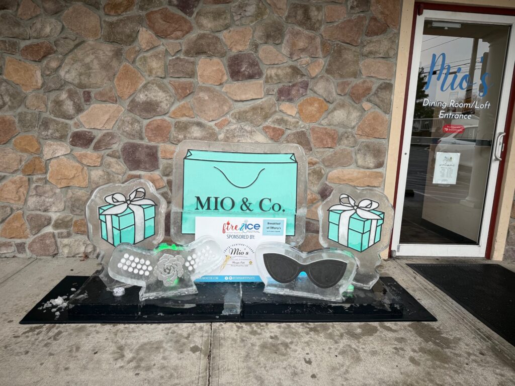 a couple of ice sculptures sitting on top of a sidewalk