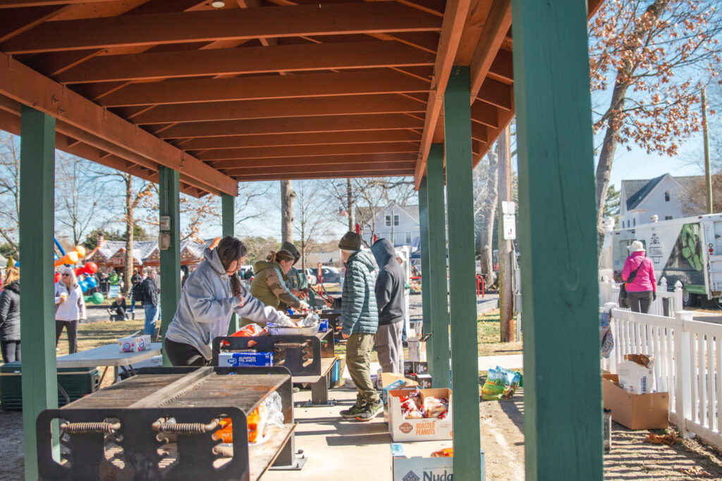 a group of people standing around a table