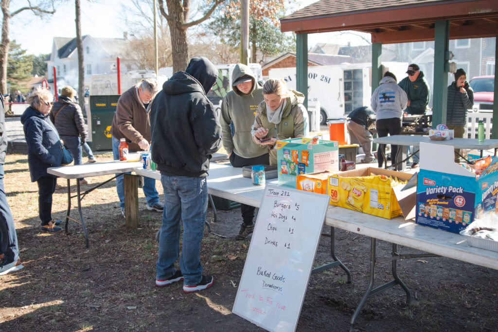 a group of people standing around a table