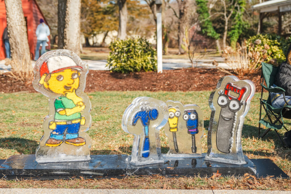 a statue of a man sitting on a park bench