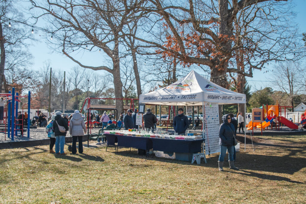 a group of people standing around a tent