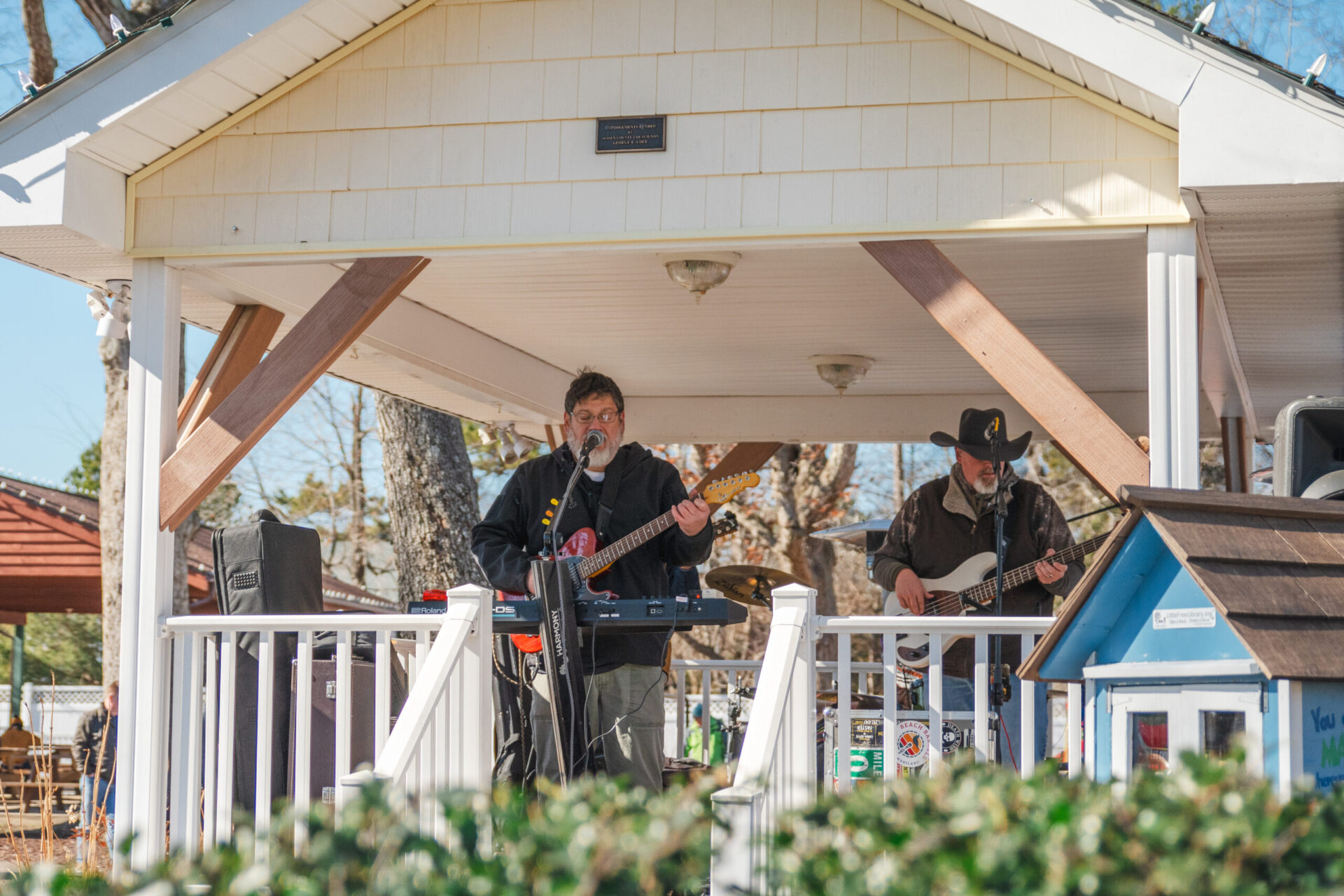a group of people playing music on a porch