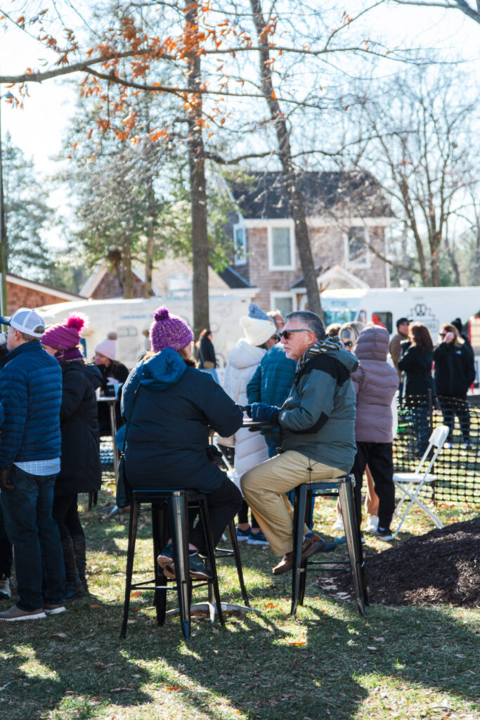 a group of people sitting at a table in a park