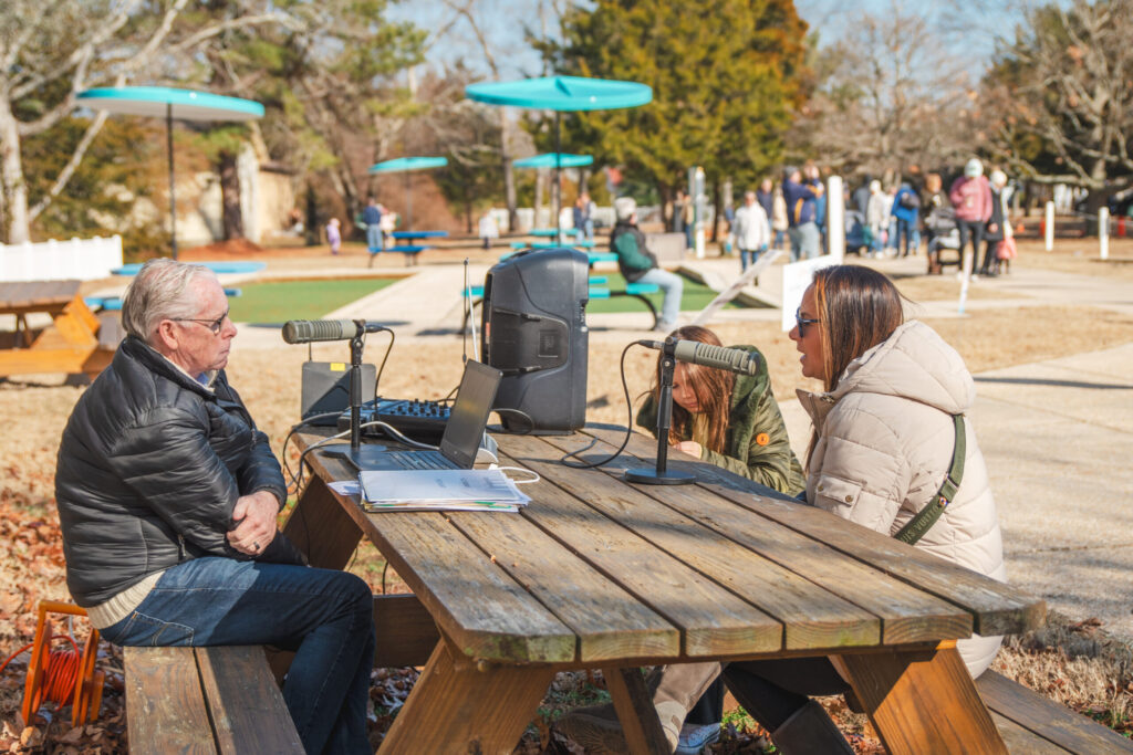 a group of people sitting at a picnic table