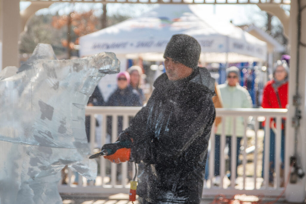 a man standing in front of an ice sculpture