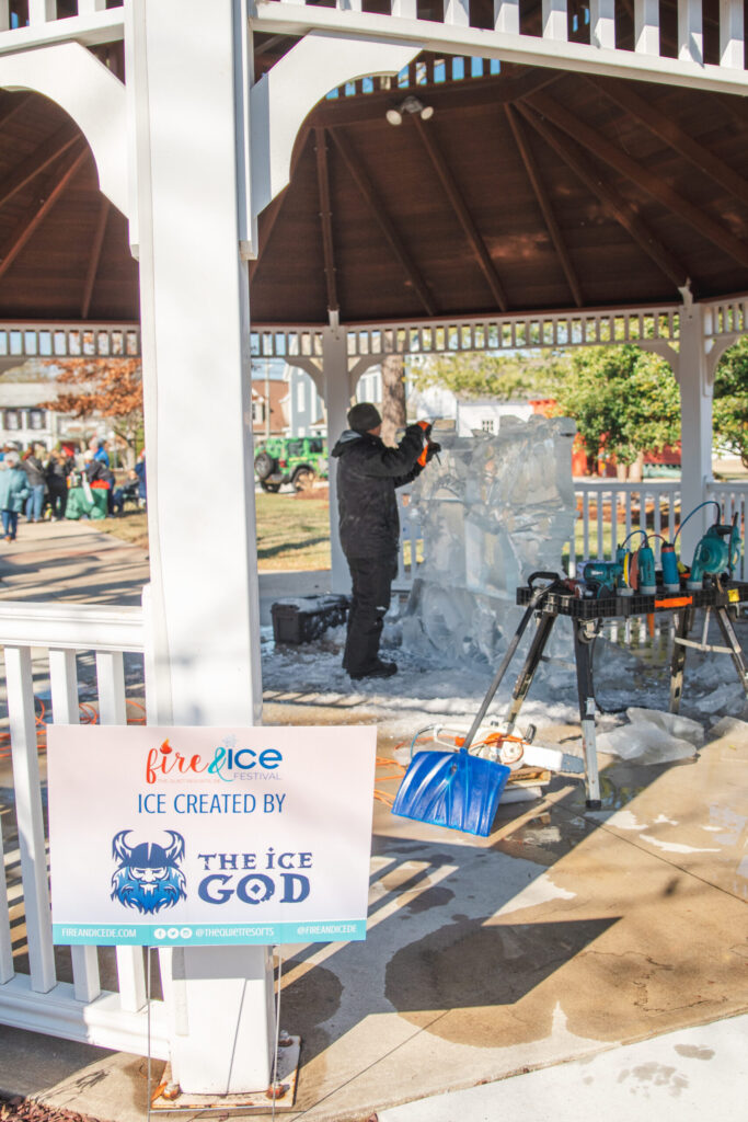 a man standing under a covered area next to a sign