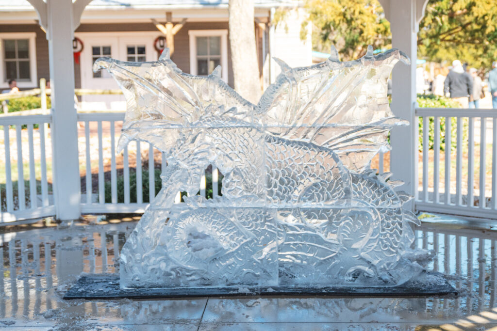 a glass sculpture of a dragon on a table