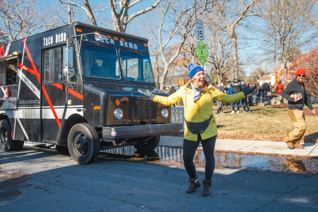 a woman in a yellow jacket standing next to a truck