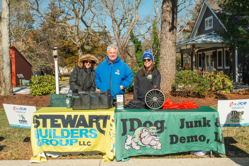 a group of people standing behind a table