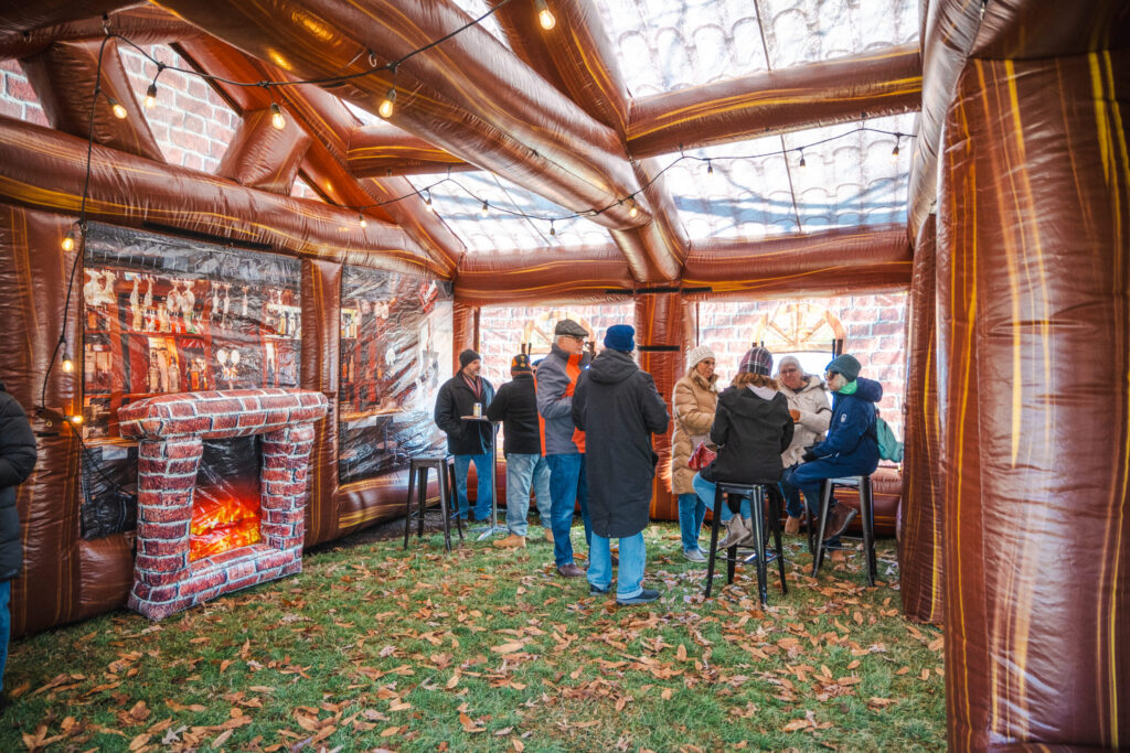 a group of people standing around a fire place