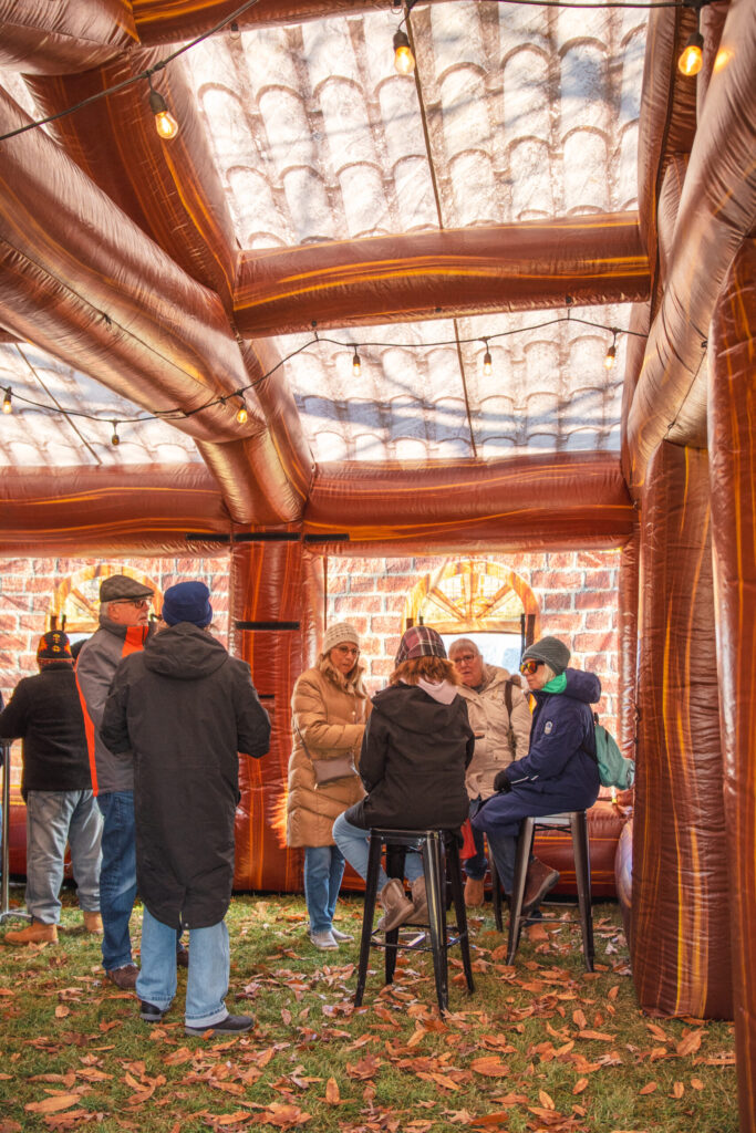 a group of people standing around a tent