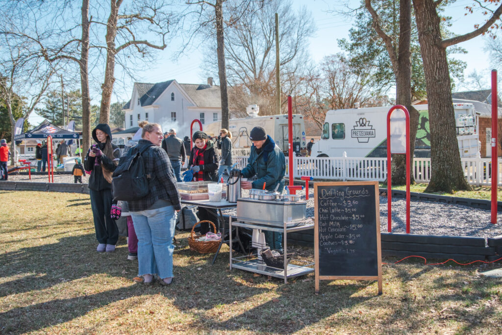 a group of people standing around a table