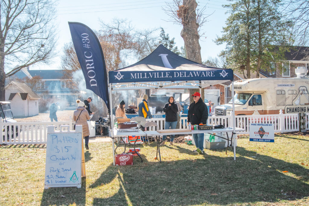 a group of people standing in front of a tent