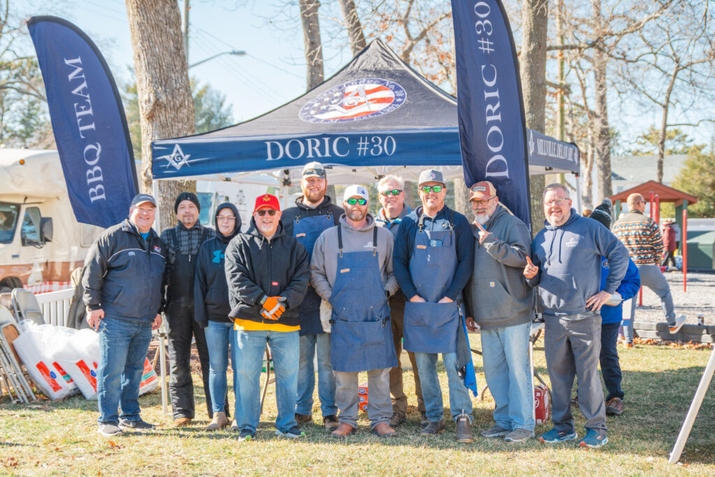 a group of people standing in front of a tent