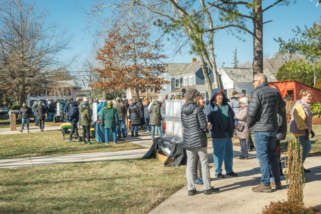 a group of people standing on a sidewalk