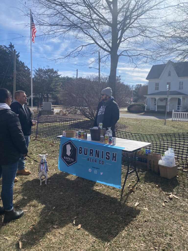 a group of people standing around a table