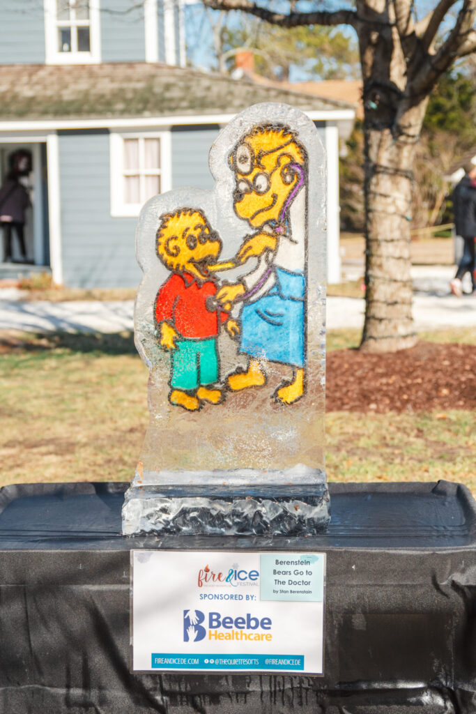a statue of a man and a child on top of a trash can