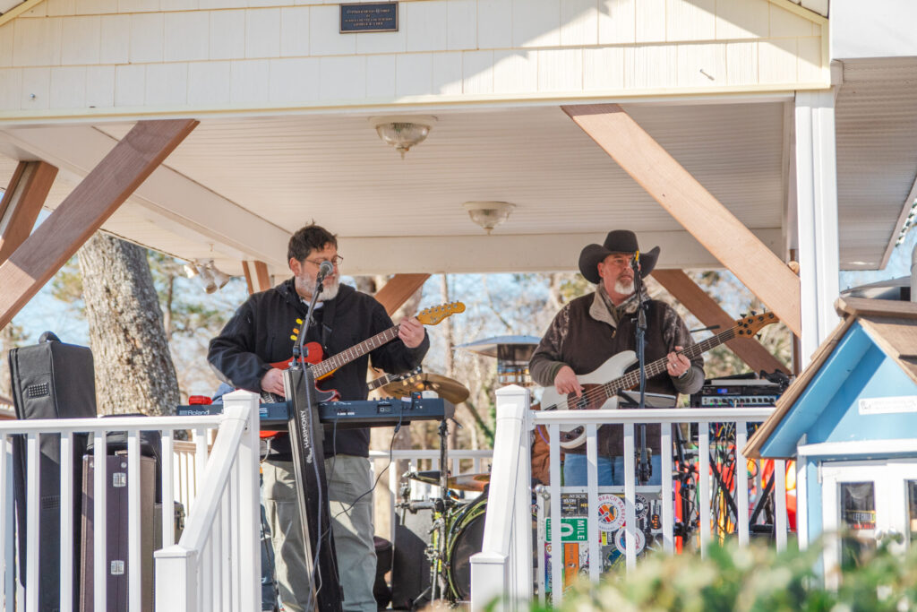 a group of men standing on top of a porch