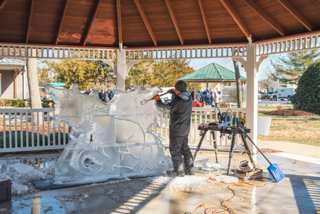 a man working on a sculpture in a gazebo