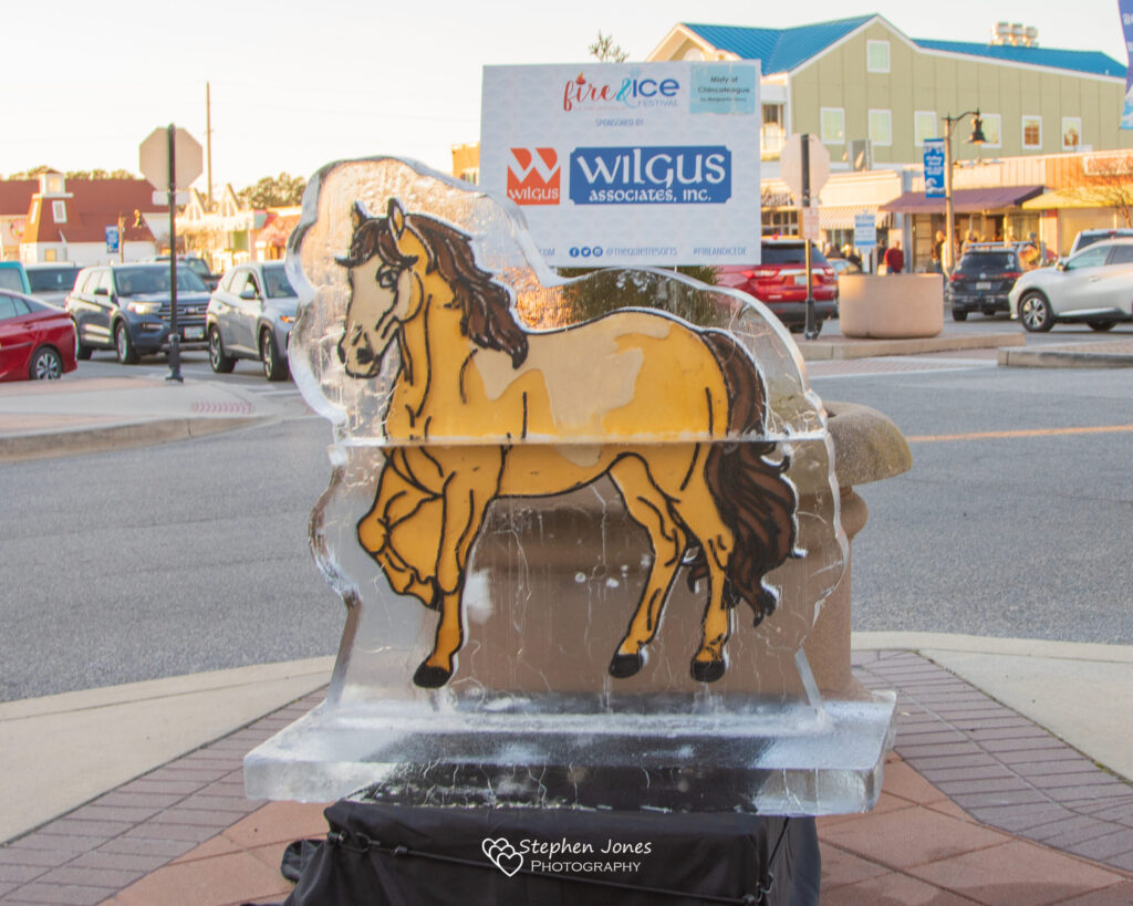 a yellow horse statue on the side of the road