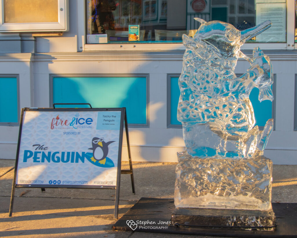 an ice sculpture of a penguin in front of a building
