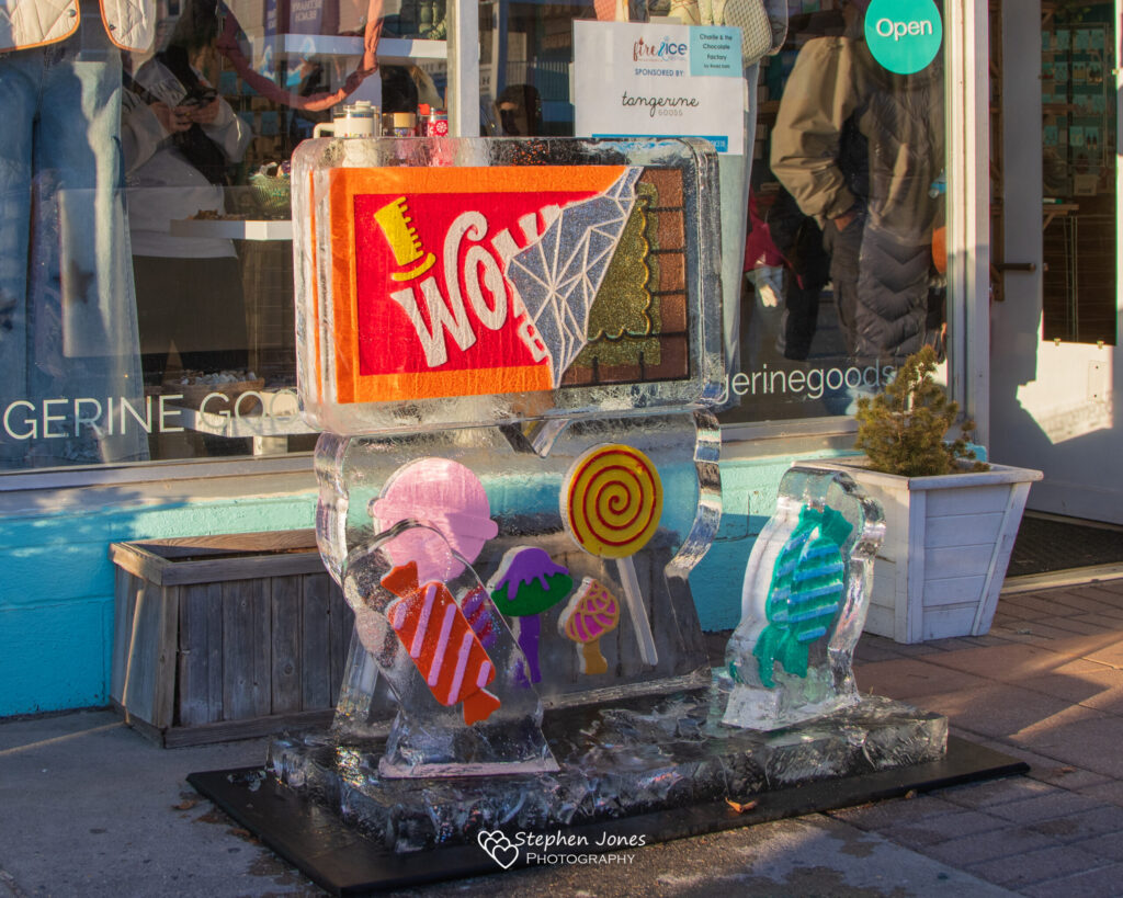 a store front with a sculpture of candy in front of it