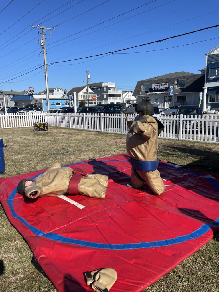 a man laying on top of a red tarp