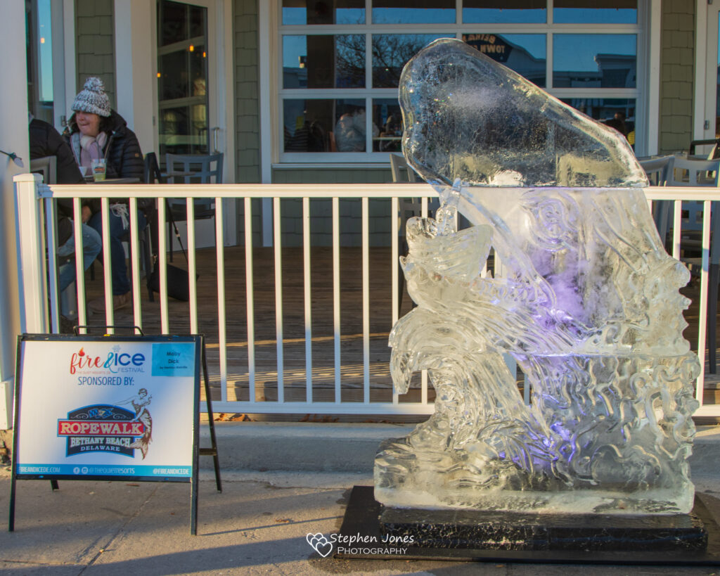 a sculpture of a person on a bench in front of a building