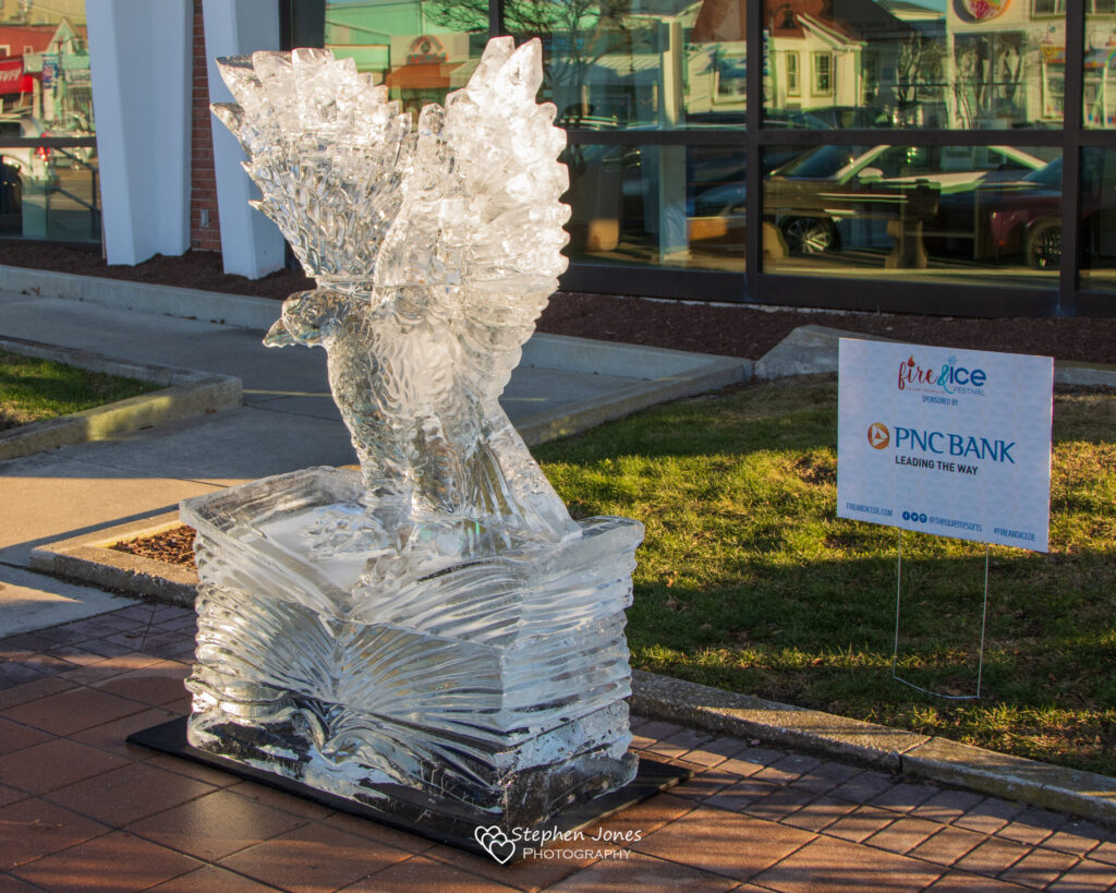 a statue of an angel on a block in front of a building