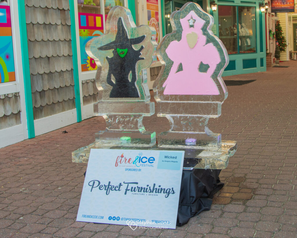 an ice sculpture of a wizard and a witch on a pedestal