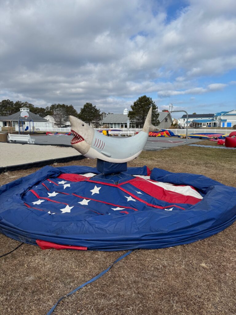 a shark kite on the ground in a parking lot