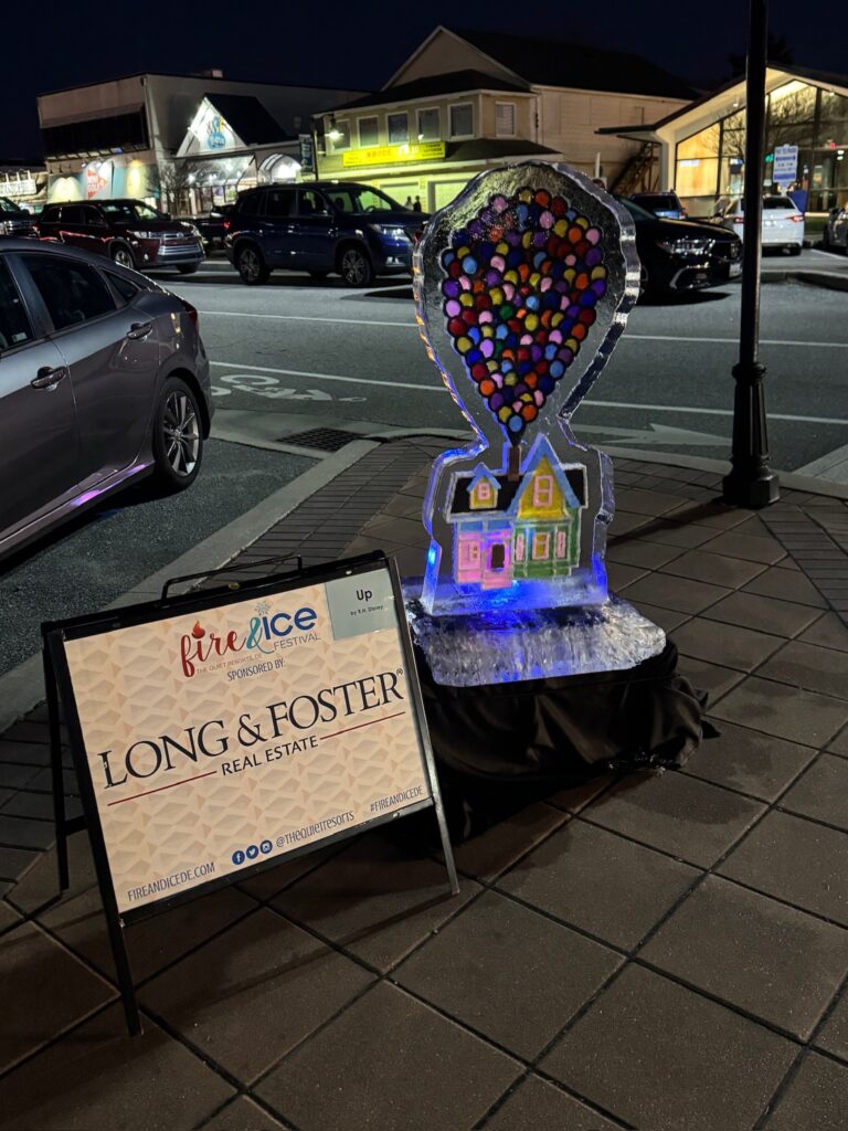 a sign on the side of a road next to a building