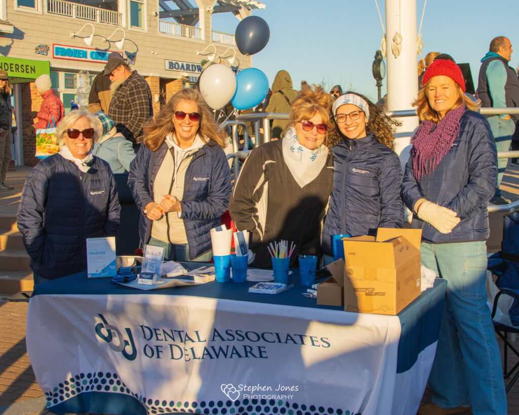 a group of people standing around a table