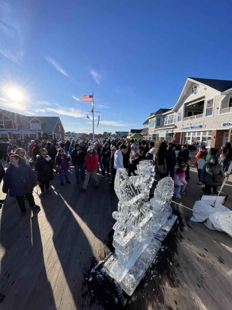 a group of people walking down a street next to a building