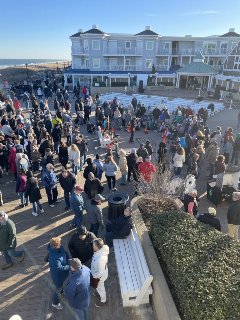 a crowd of people standing on top of a parking lot