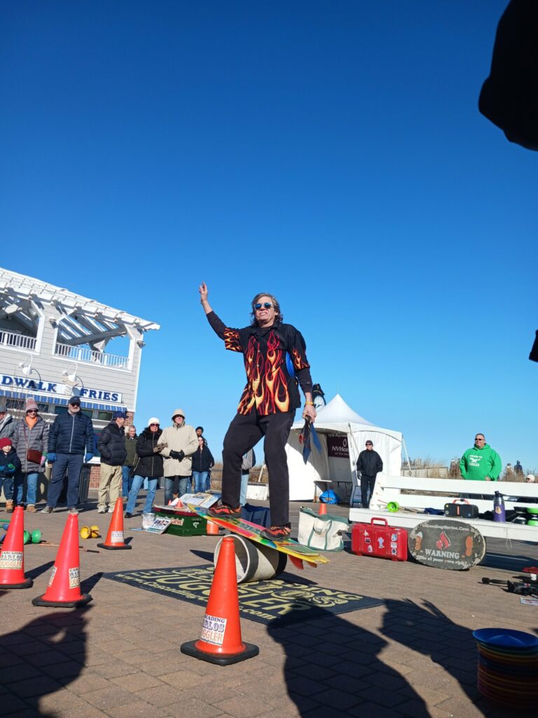 a man riding a skateboard through orange cones