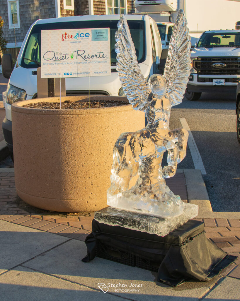 a statue of an angel on a street corner