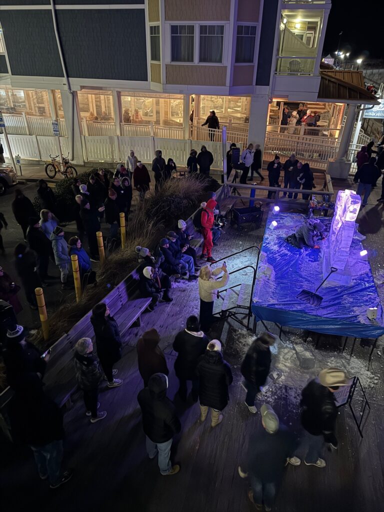 a crowd of people standing around a stage