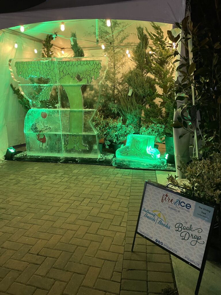 a white tent with a sign in front of it