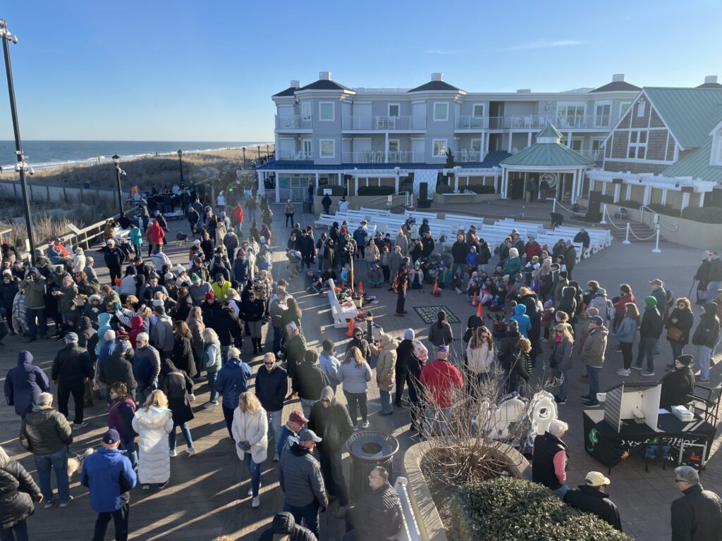 a crowd of people standing on top of a parking lot