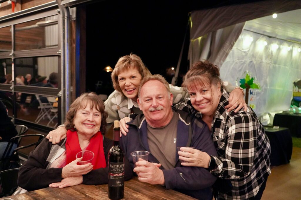 a group of people posing for a picture at a table