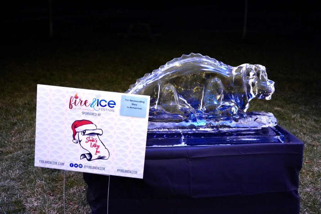 an ice sculpture with a sign in front of it