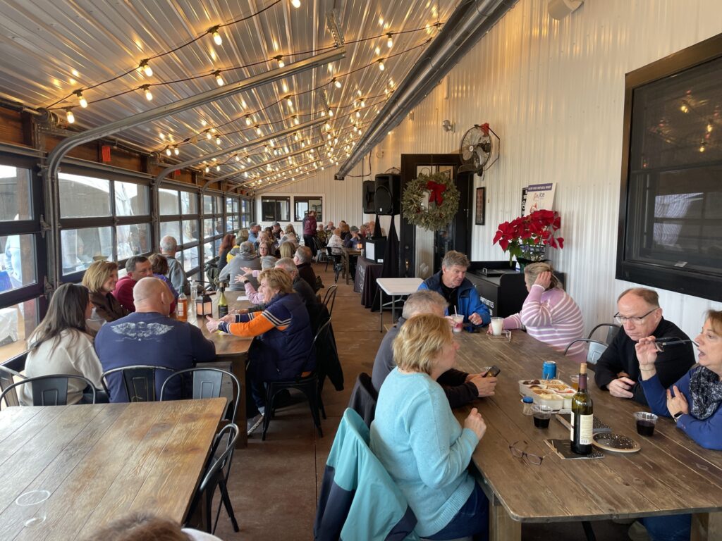 a group of people sitting around a wooden table