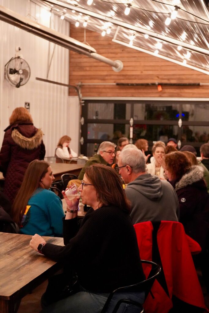 a group of people sitting around a wooden table