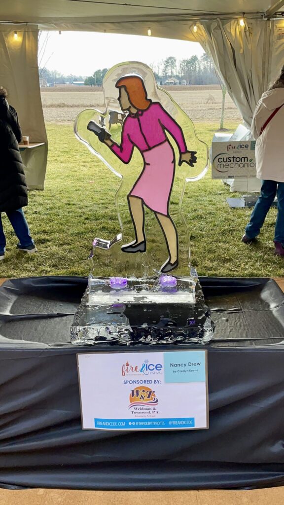 a woman in a pink dress standing in front of a sign