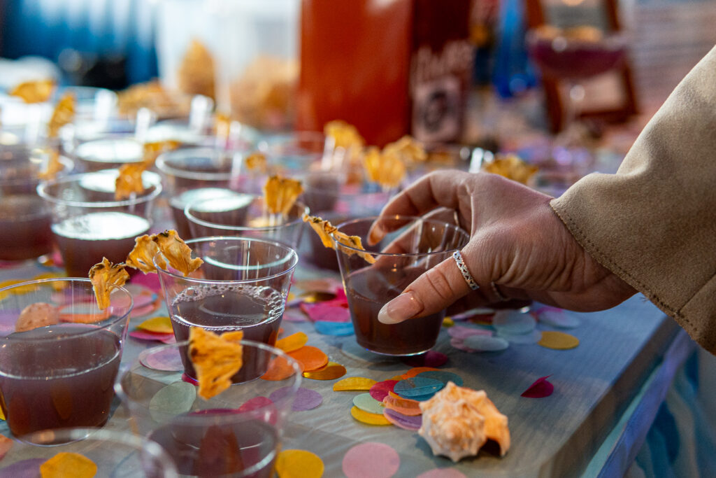 a table topped with lots of glasses filled with liquid